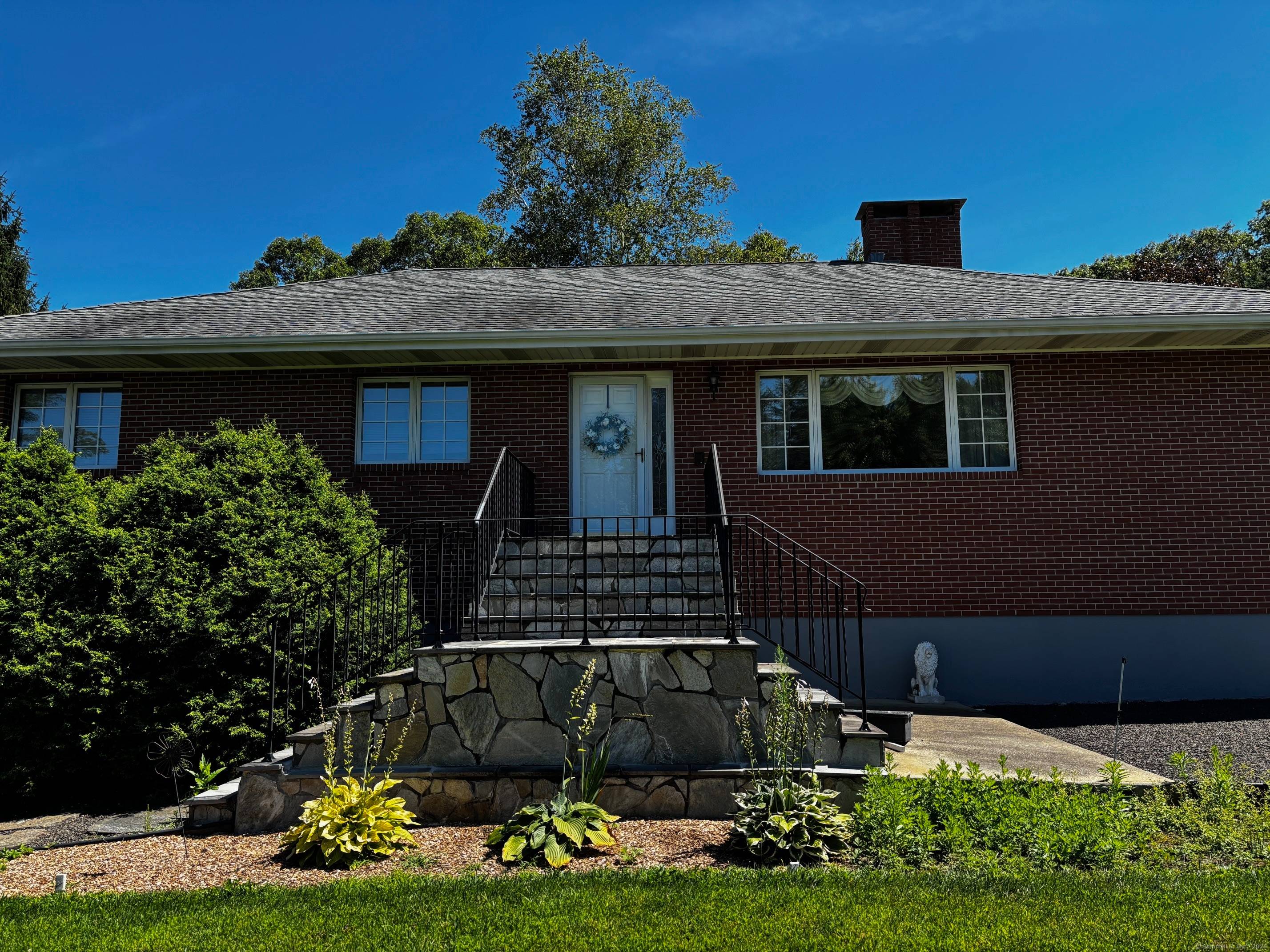 Experience peaceful country living in this charming brick ranch, perfectly positioned on a quiet road amidst beautifully landscaped grounds.