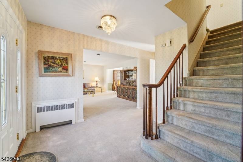 Nestled on a generous, nearly half acre lot in a desirable Glen Rock location, this classic 4 bedroom, 2.