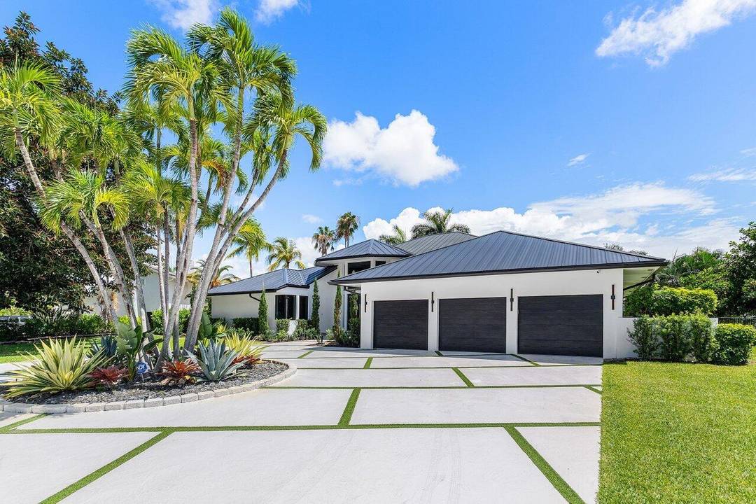 Set on a private half acre overlooking the 6th green in Bocaire Country Club, this fully transformed contemporary residence delivers a rare blend of scale, design, and functionality.