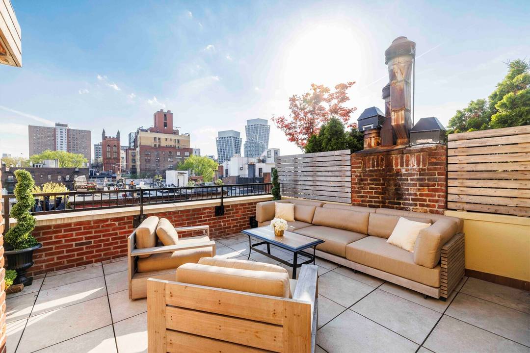 This exceptional Chelsea townhouse penthouse duplex opens to remarkable light, volume, and sweeping views over West Chelsea's historic rooftops.