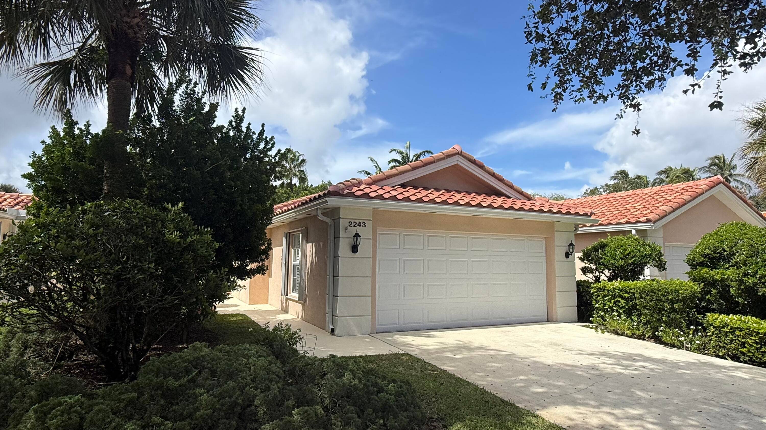 Spectacular wide lake view from the custom screened pool of this 2BR 2BA Capri model villa.