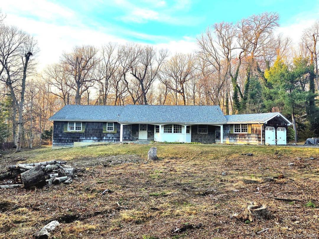 An Exceptional Estate Opportunity in Prestigious Point of Woods, Dix Hills.