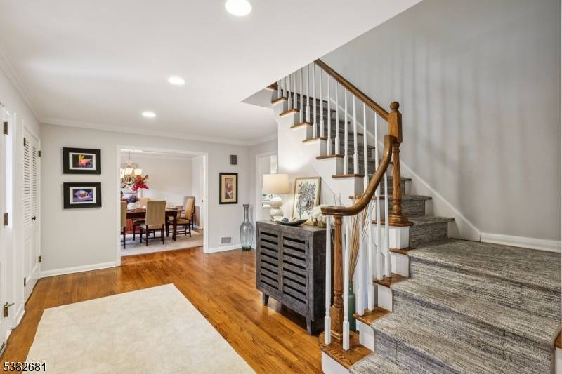 Elegant expanded custom colonial perfectly perched on lushly landscaped grounds will astound.