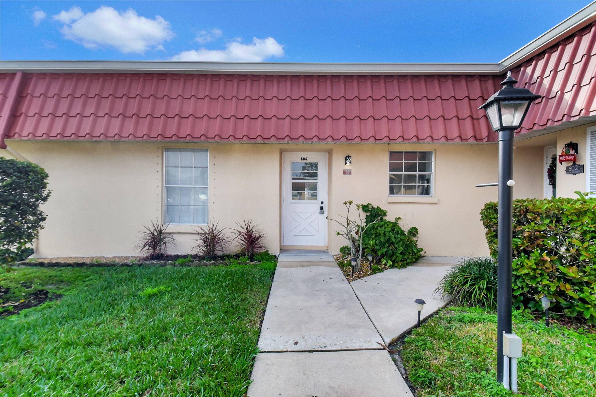 FREE SIX MONTHS OF HOA ! LAKEFRONT VILLA WITH MODERN UPGRADES AND BREATHTAKING WATER VIEWS.