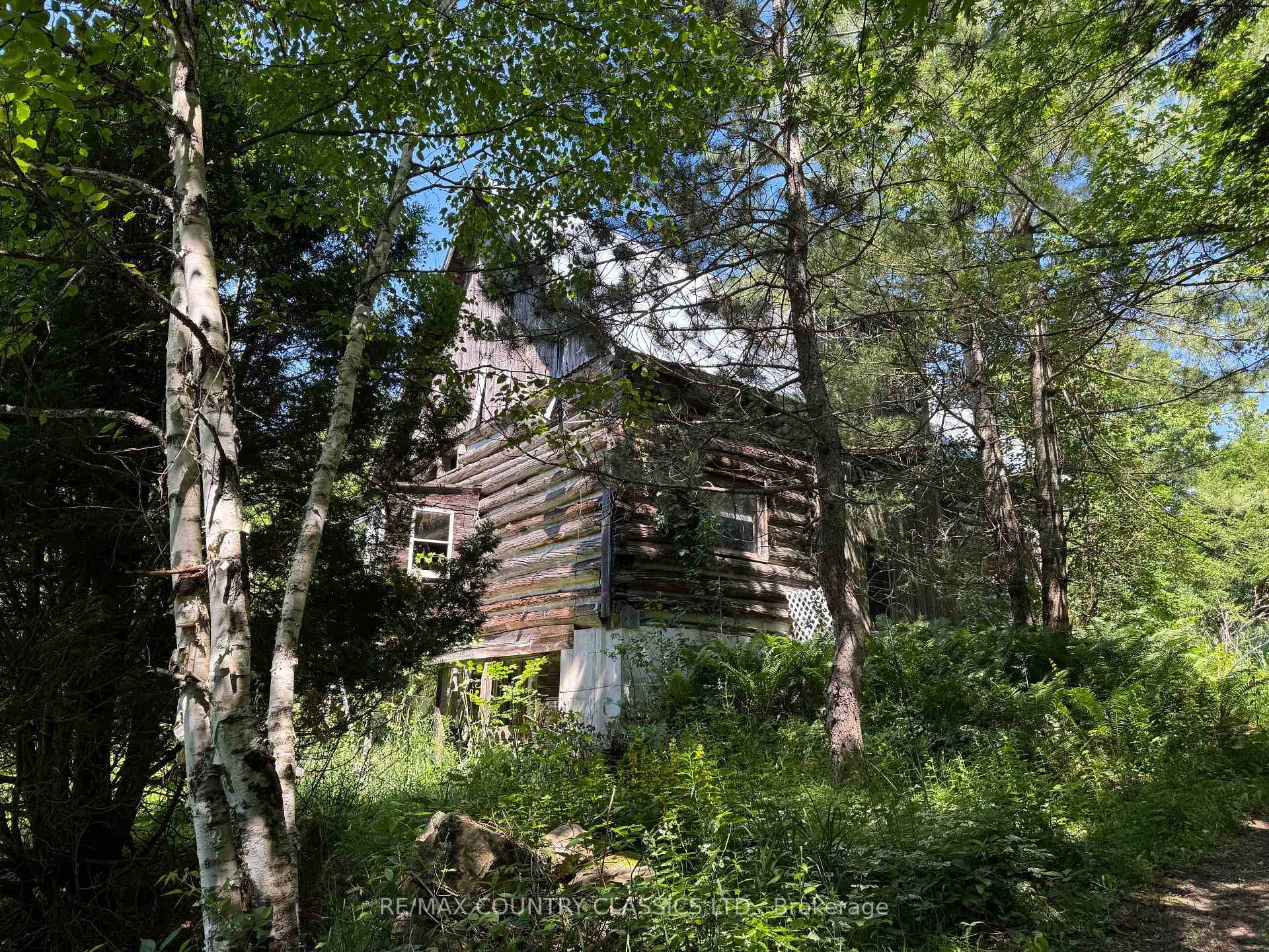 Great potential ! Two bedroom log home situated back from the road in 89.