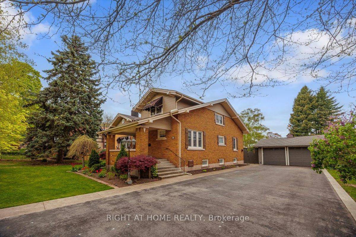 Welcome to 16 Nelles Boulevard a timeless Schafer built century home nestled beneath the Niagara Escarpment on one of Grimsby's most iconic tree lined streets.