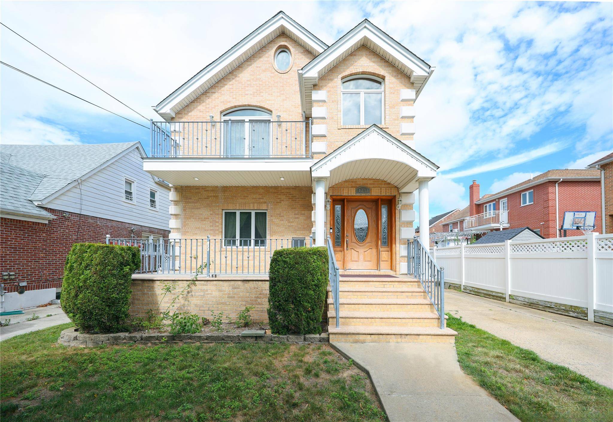 Stunning 2008 custom built solid brick two family home, nestled on a quiet, tree lined street in the heart of Flushing, Queens.