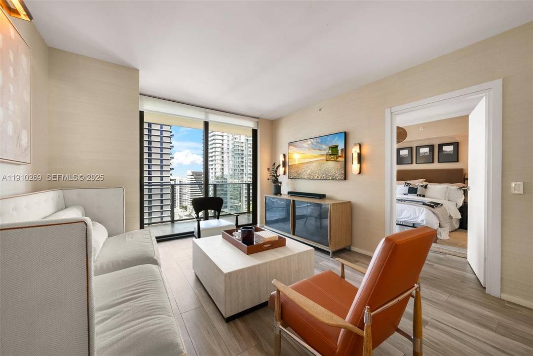 Impeccably designer redone residence at SLS Lux featuring statement Visual Comfort amp ; Kelly Wearstler lighting throughout and sophisticated Thibaut wallpaper.