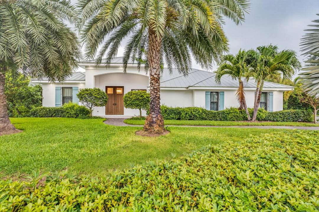 Poised upon a spacious. 52 acre cul de sac lot east of A1A, this meticulously renovated home is just a short walk to a serene beach with private deeded access.