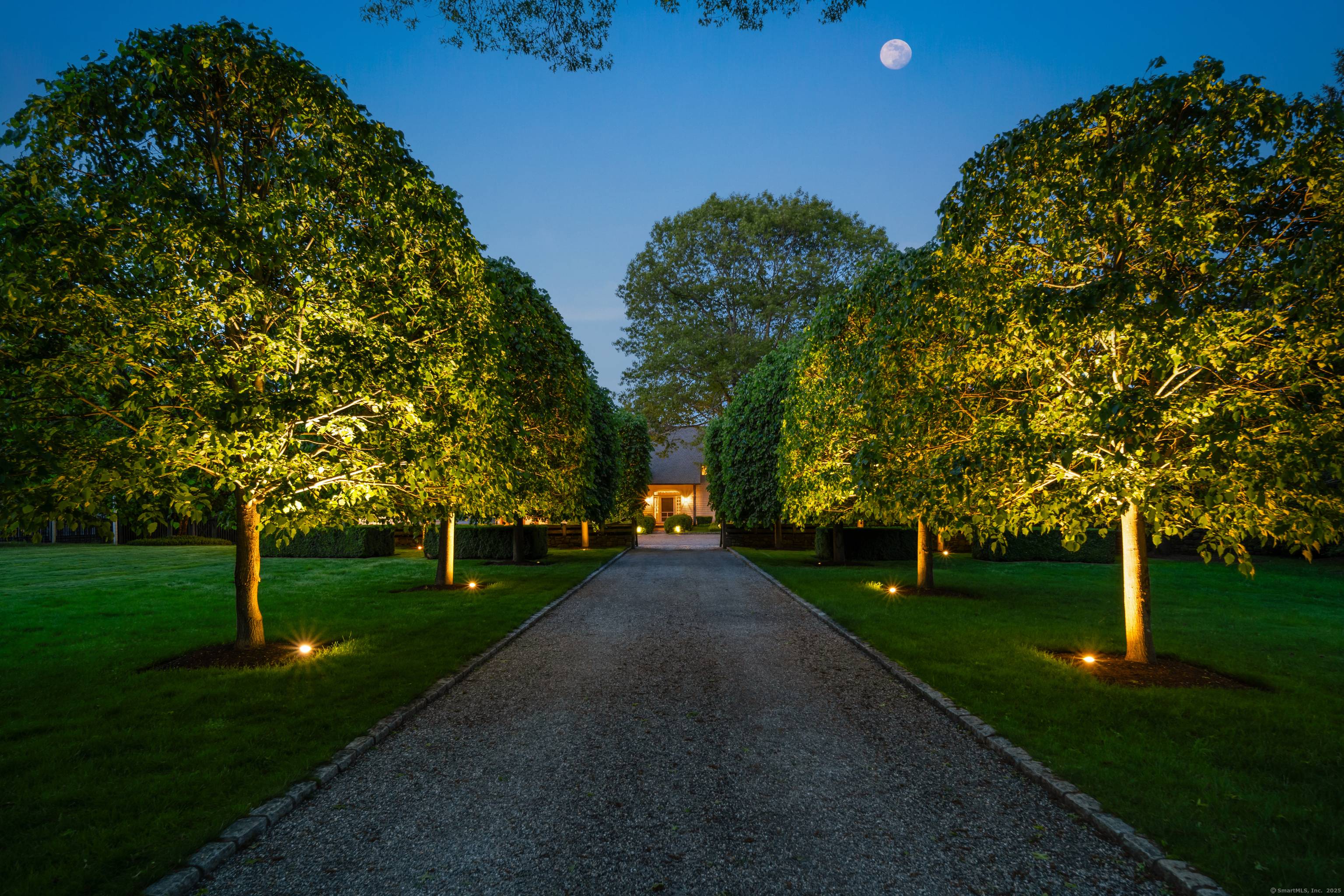 Nestled on over five private acres along one of New Canaan's most distinguished streets, this estate perfectly balances historic character with modern luxury.