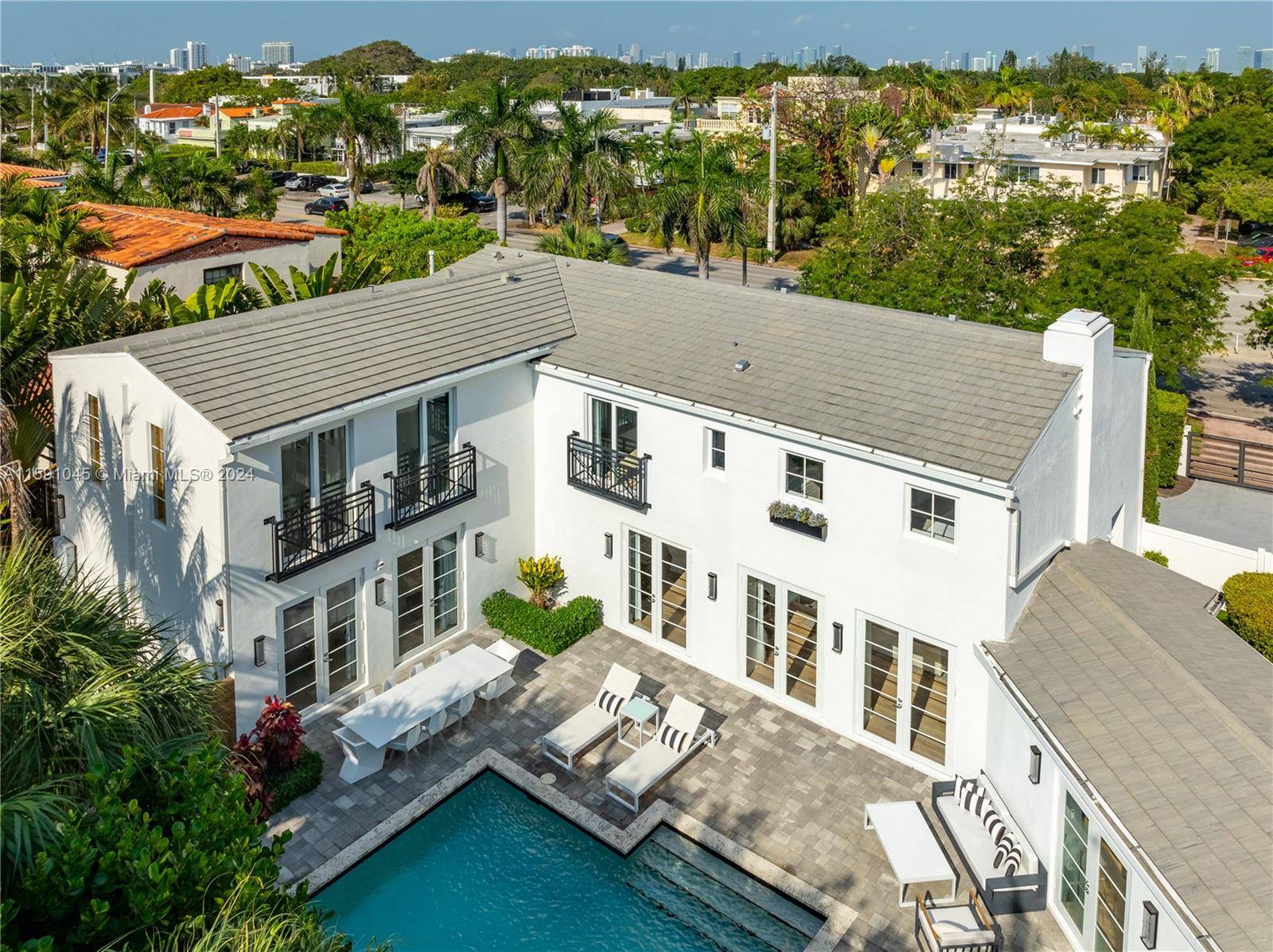 Offered fully furnished, this luxurious Miami Beach estate presents a seamless blend of grandeur and chateau elegance.