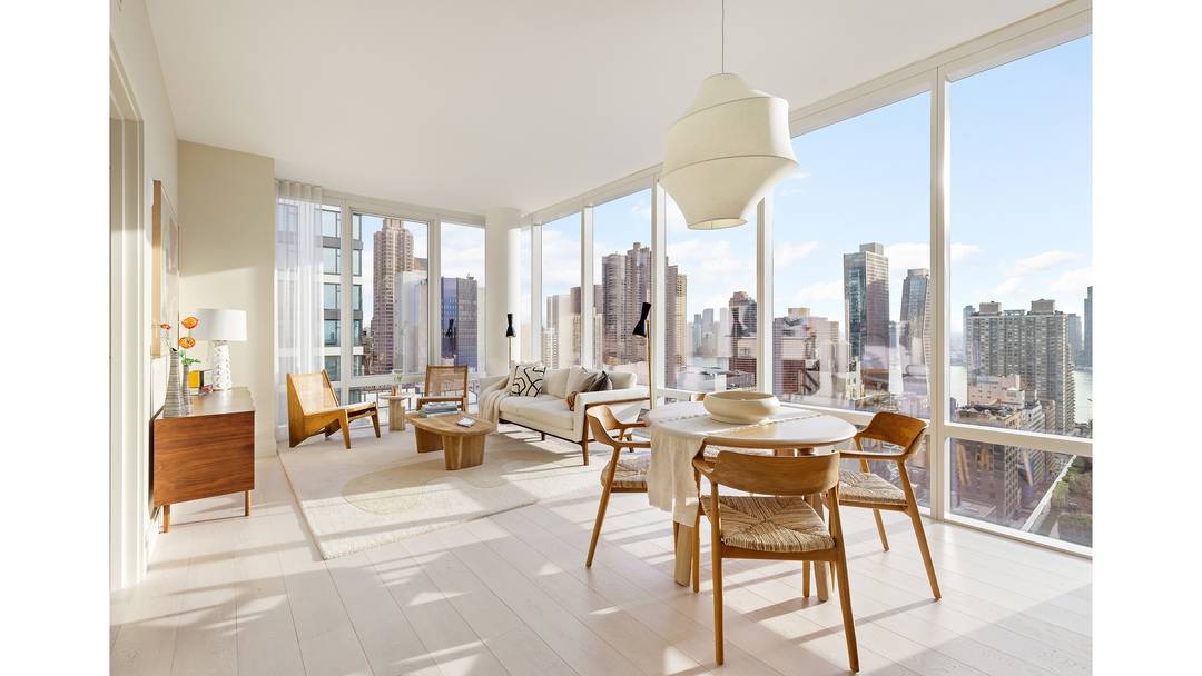 Luxury corner home with 10' floor to ceiling windows and expansive views of the River, Manhattan skyline and Long Island City.