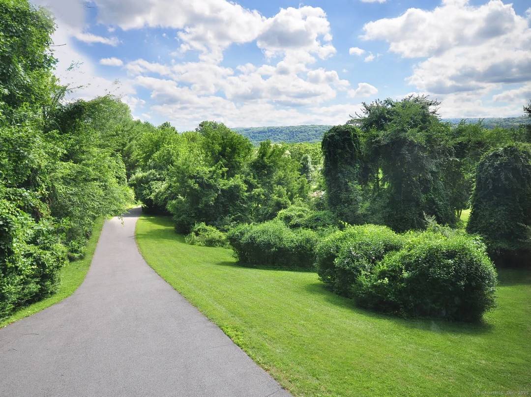 Spacious and open with high ceilings, this pool home is set on over 4 acres of quiet, wooded surroundings.