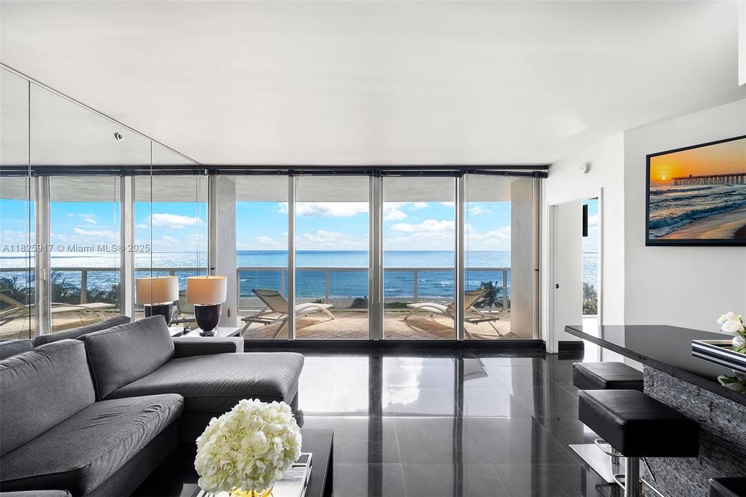 This beautifully appointed residence is situated on a low floor, offering a unique connection to the ocean with tranquil views and refreshing breezes enjoyed from the expansive terrace.