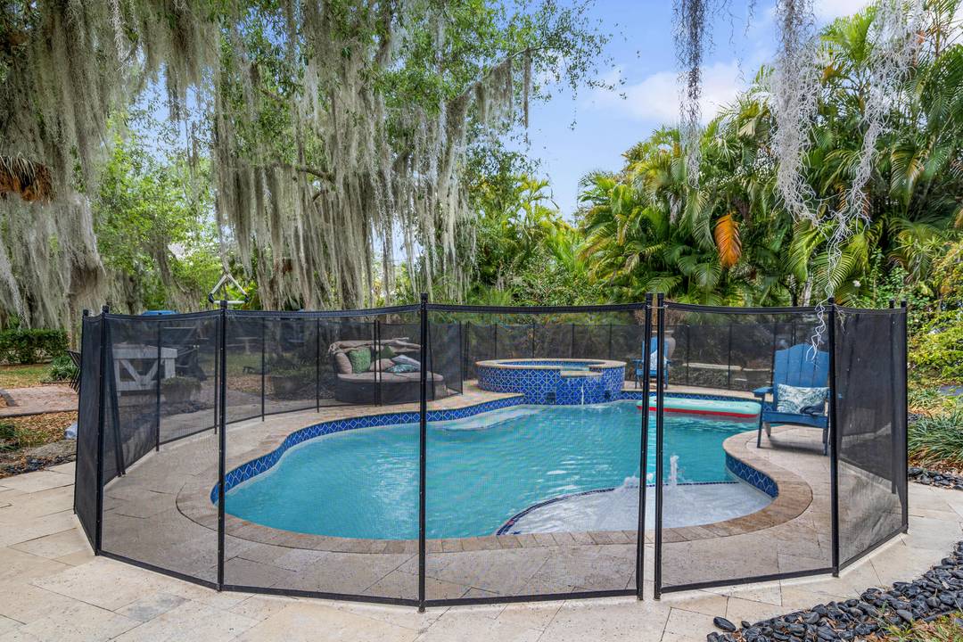 303 Lang Road Two Homes on the Lake with Pool Hot TubWelcome to your waterfront retreat, where old Florida charm meets modern comfort.