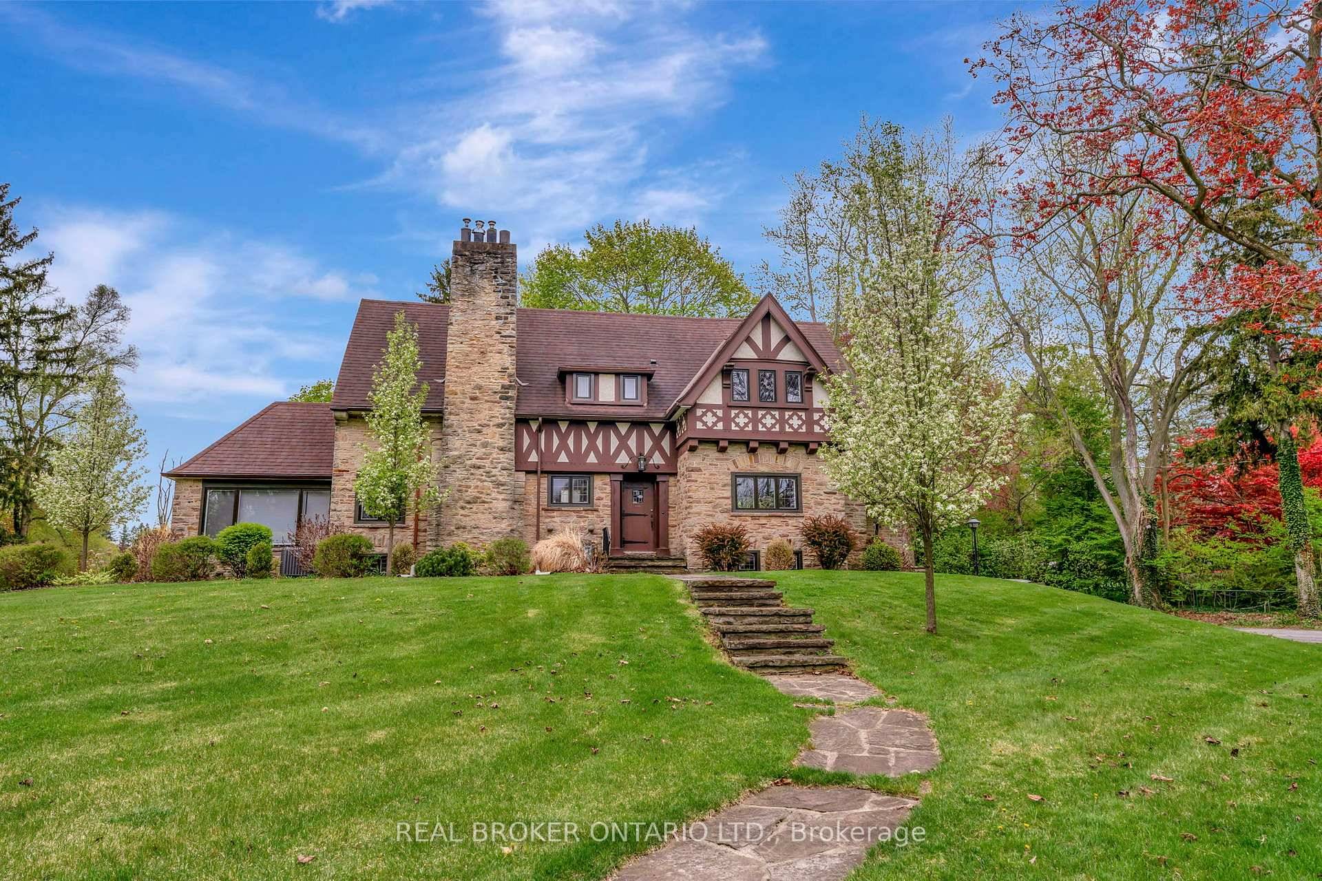 This exceptional 4 bedroom, 5 bath custom designed English Tudor style executive home, set on nearly an acre in the heart of Town, seamlessly combines historic charm with modern updates.