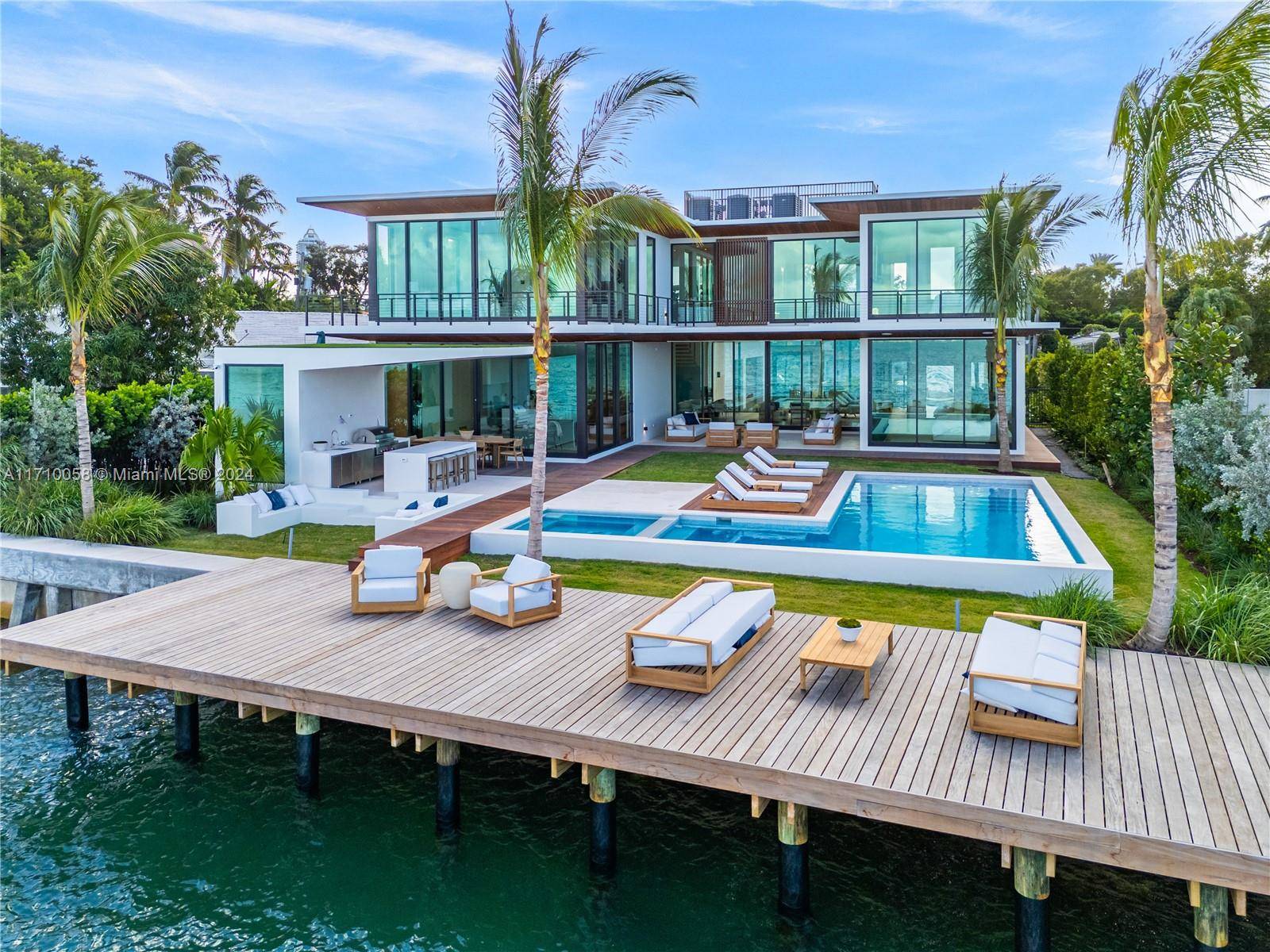 Discover the pinnacle of luxury on North Bay Road with this stunning new modern mansion offering wide bay views and breathtaking sunsets over Biscayne Bay.