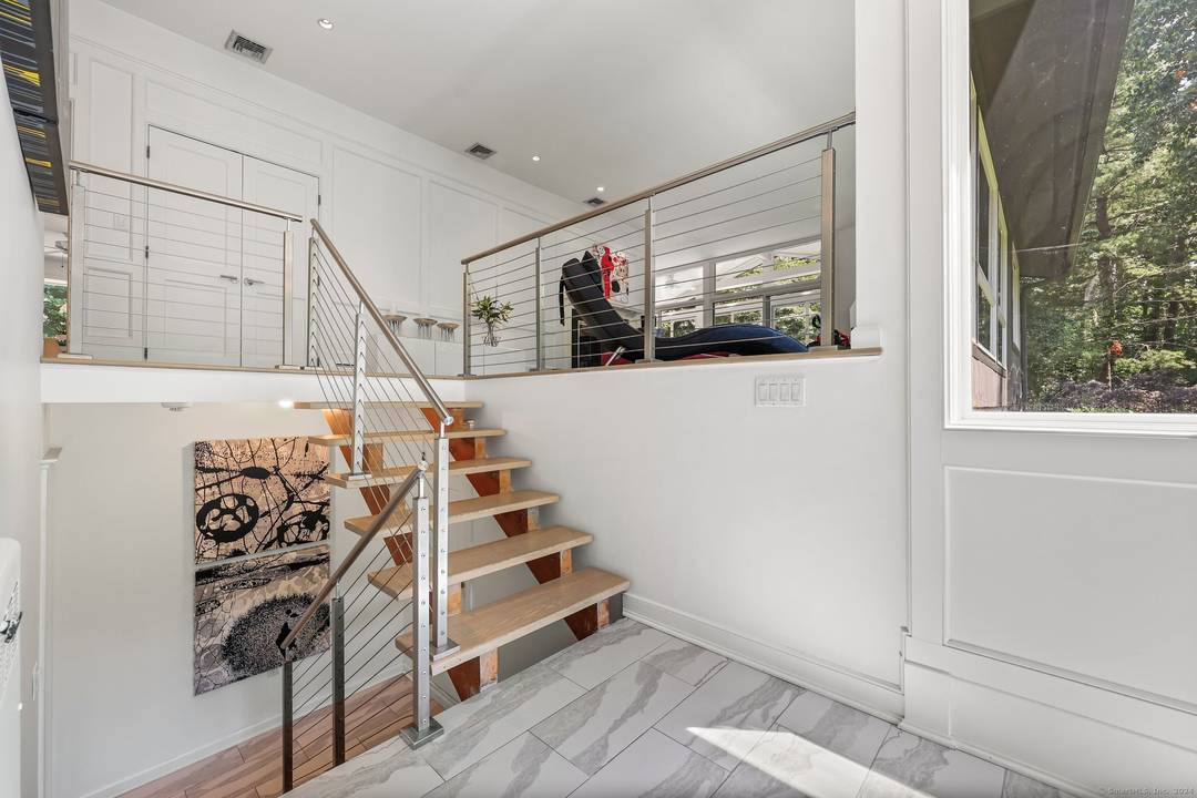 Welcome to this exquisite Mid Century Modern home, nestled on a private acre in the highly sought after Delafield Island Association in Darien.