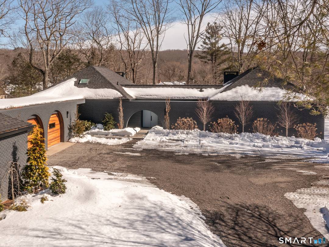 This beautifully reimagined Mid Century home sits on a picturesque stretch of the Bantam River.