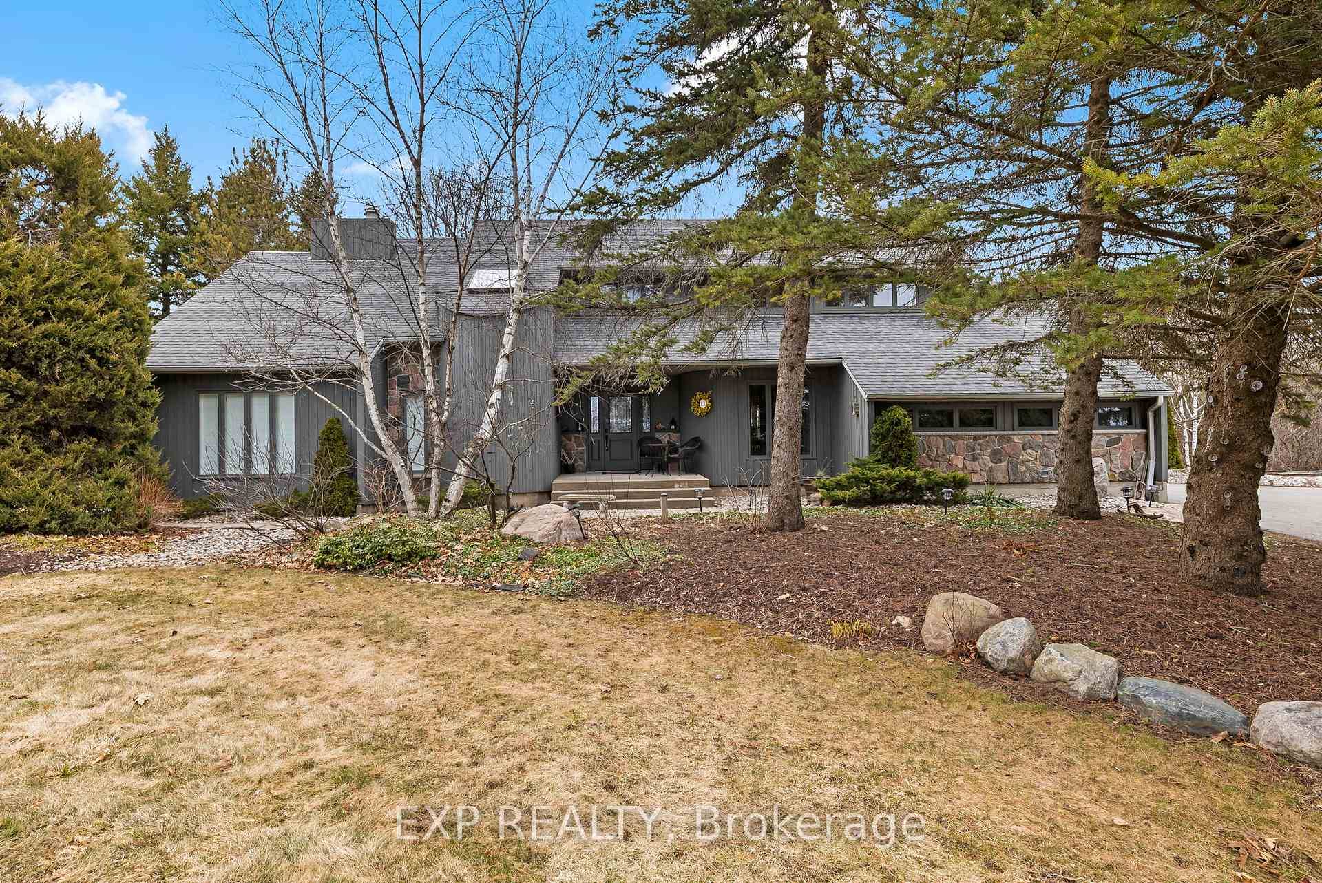 Nestled on a breathtaking treed property with a circular drive, this custom built 2 storey home blends timeless wood and stone exterior with refined, tasteful interiors.