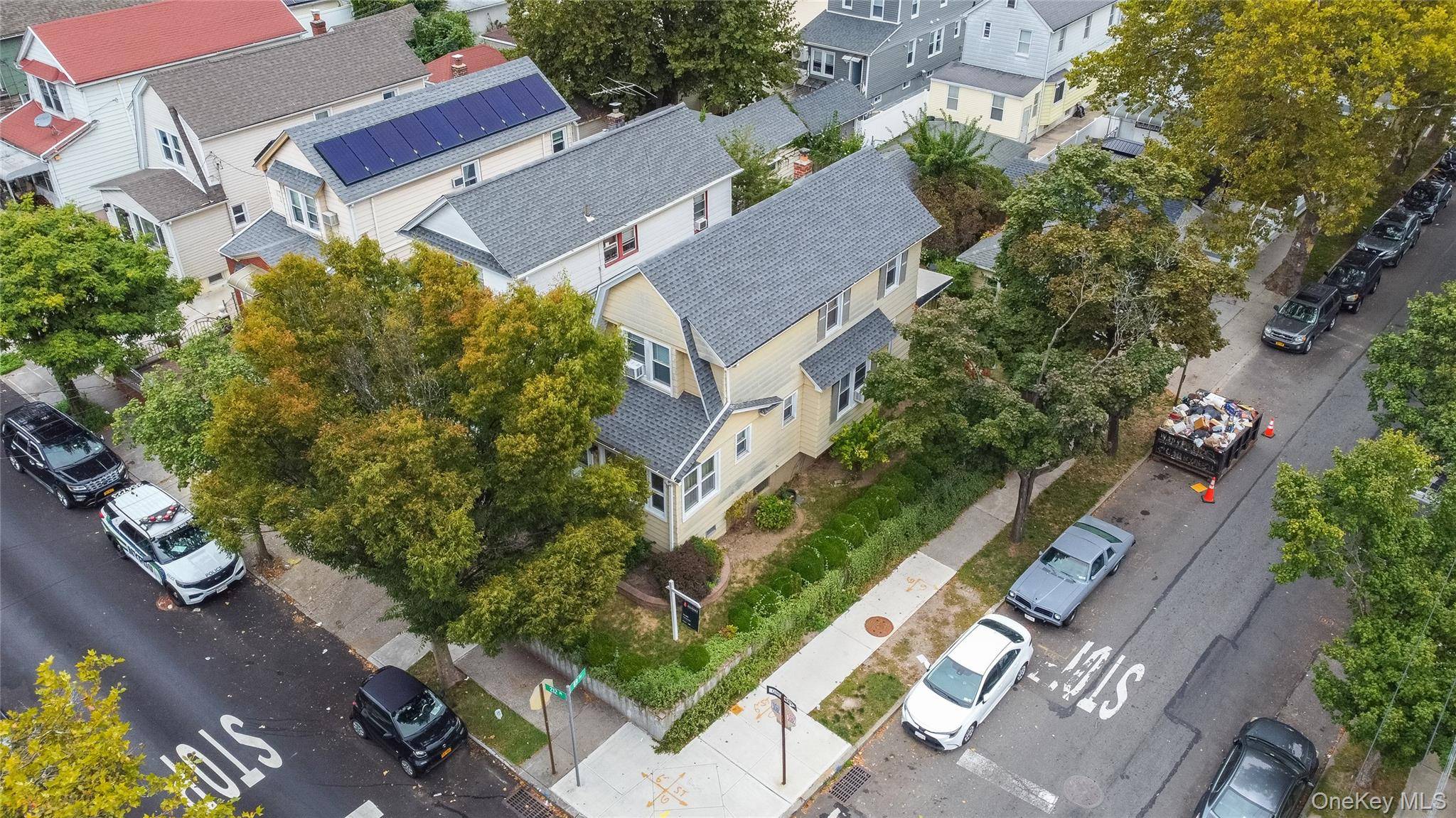 Welcome to 88 49 212th Place an inviting detached corner lot single family in the heart of Queens Village with a rare two car detached garage and a new roof.