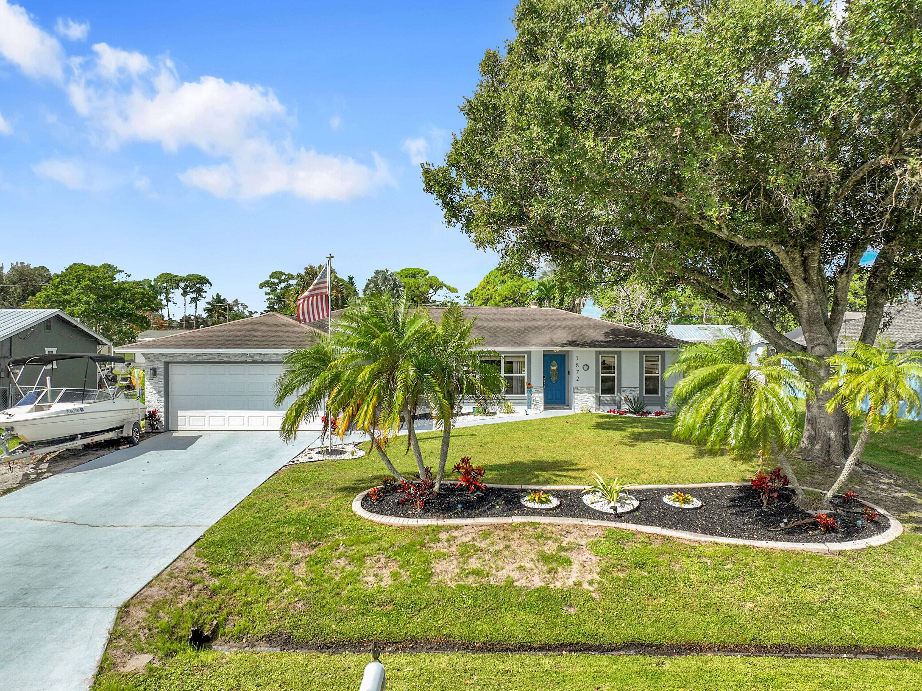 Step into this updated 3 bedroom, 2 bathroom retreat at 1872 SE Joy Haven St.