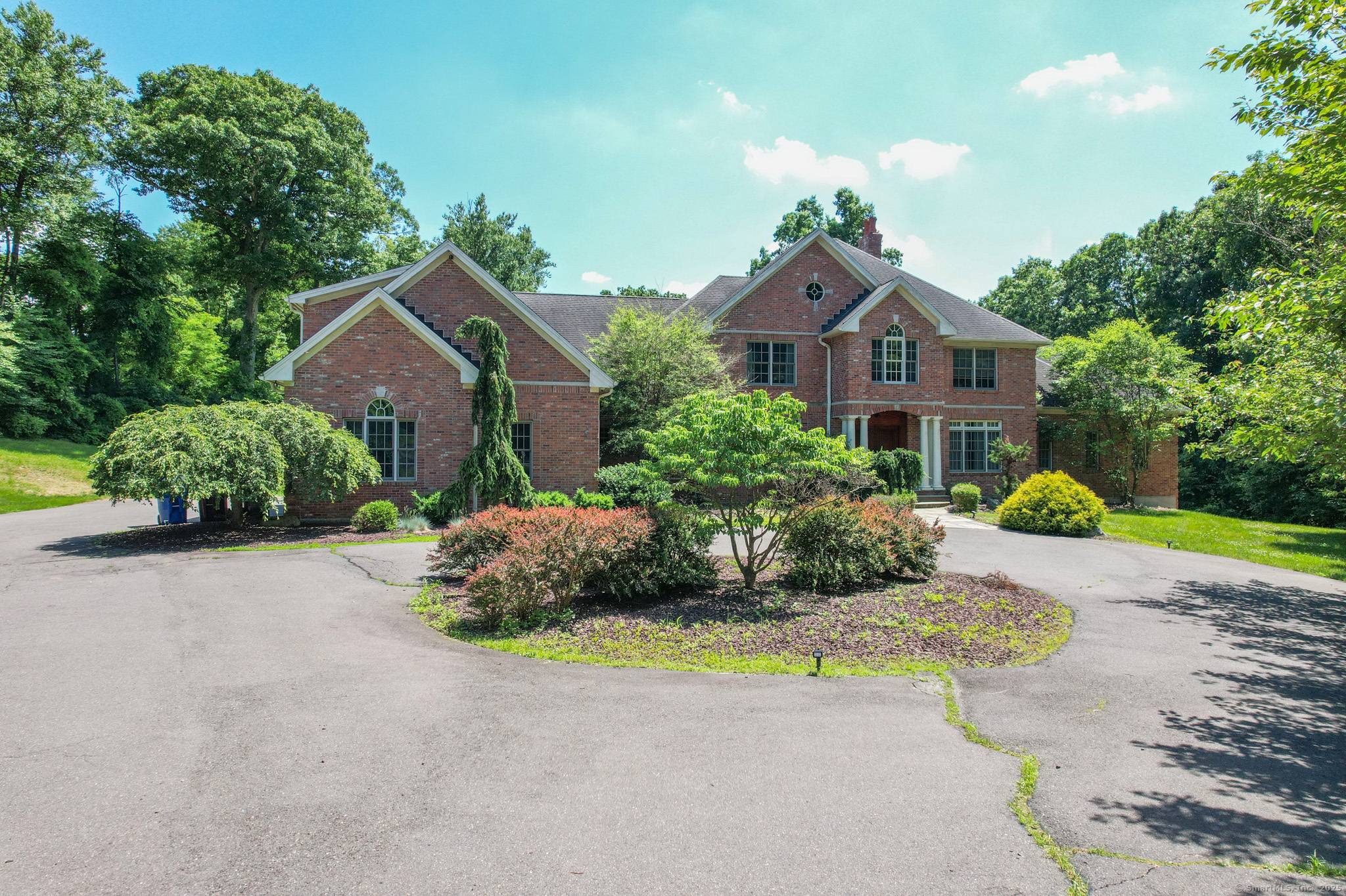 Welcome to 215 Old Mountain Road, where timeless brick Colonial elegance meets grand Connecticut living.