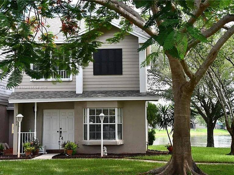 Experience tranquil lakefront living in this two story villa at Colony Courts.