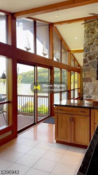 Located at the end of a peninsula, this home is surrounded by water on three sides, offering dramatic lake views that stretch down the lake.