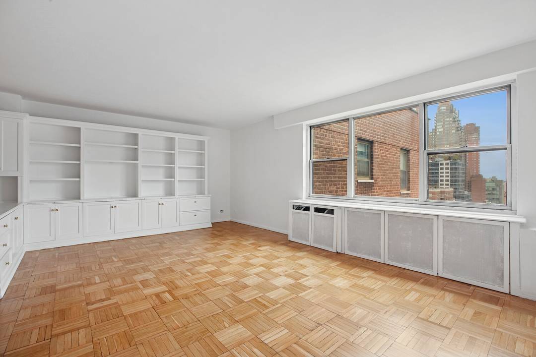 TOP floor, over sized alcove studio in deluxe post war co op in the heart of the Upper East Side.