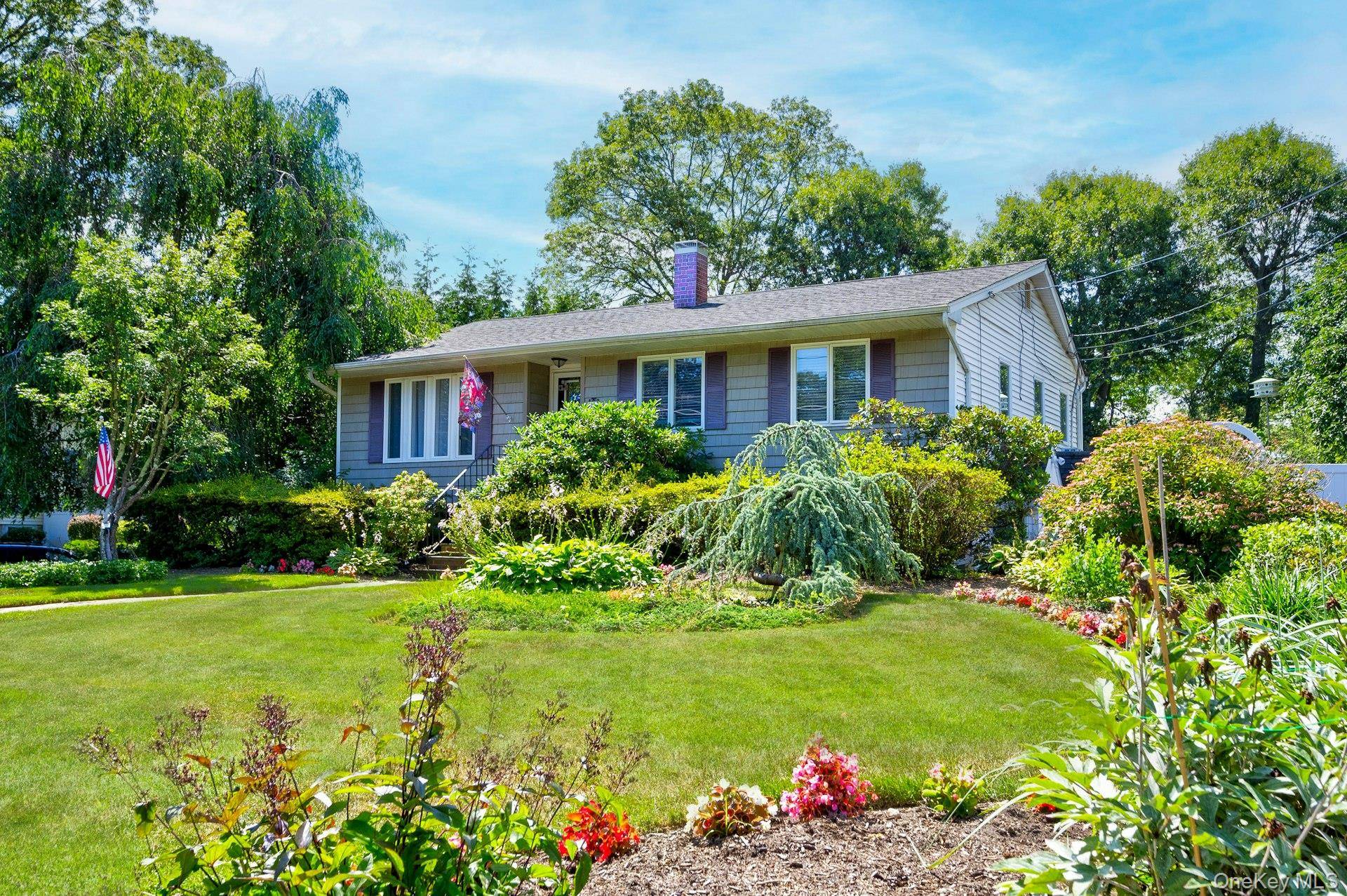 Welcome to this impeccably maintained and renovated 4 bedroom, 2 bath home in the desirable Comsewogue School District, nestled on a spacious third acre lot in beautiful Port Jefferson Station.
