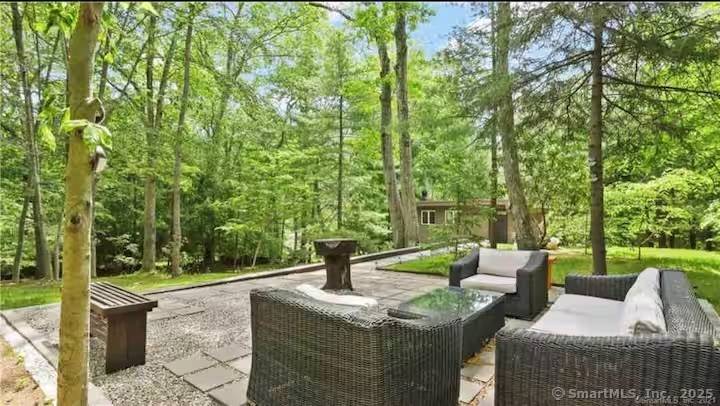 Welcome to 11 Alewives Rd a beautifully updated Mid Century Modern retreat blending comfort, character, and unmatched convenience.