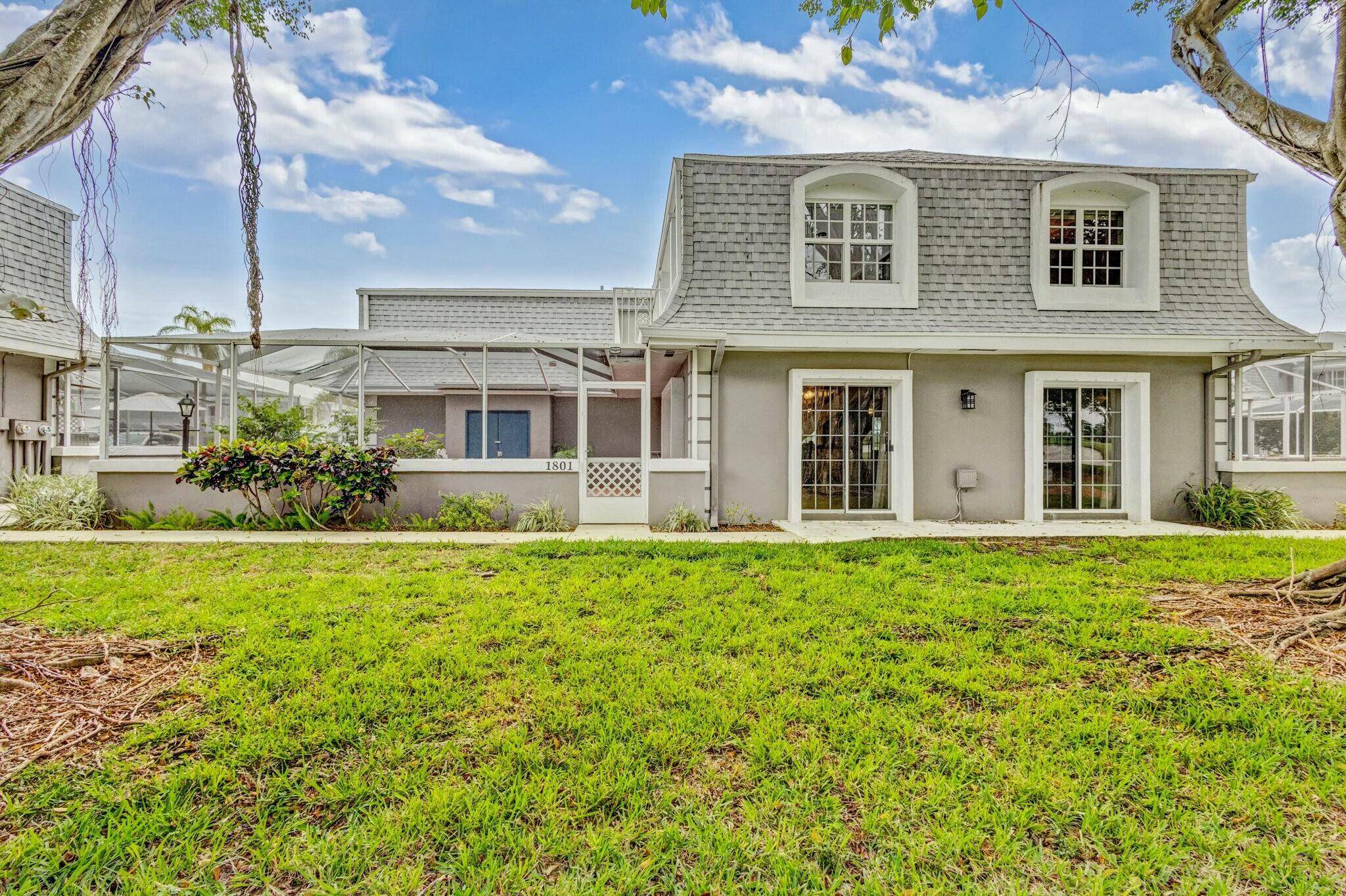Beautifully maintained corner unit townhouse overlooking the 11th hole of the BallenIsles Country Club golf course !