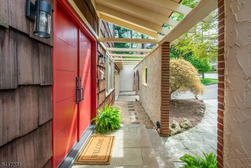 ONE OF A KIND Mediterranean inspired Center Hall Colonial located in the desirable Oldstead section of West Orange, set on over 1 3 acres with breathtaking sunrise and mountain views.