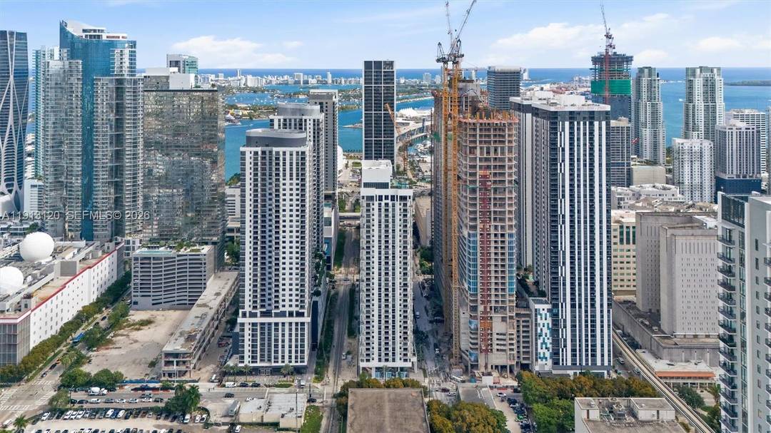 Modern studio at The Crosby Miami Worldcenter featuring floor to ceiling windows, sleek contemporary finishes, and an open concept layout.