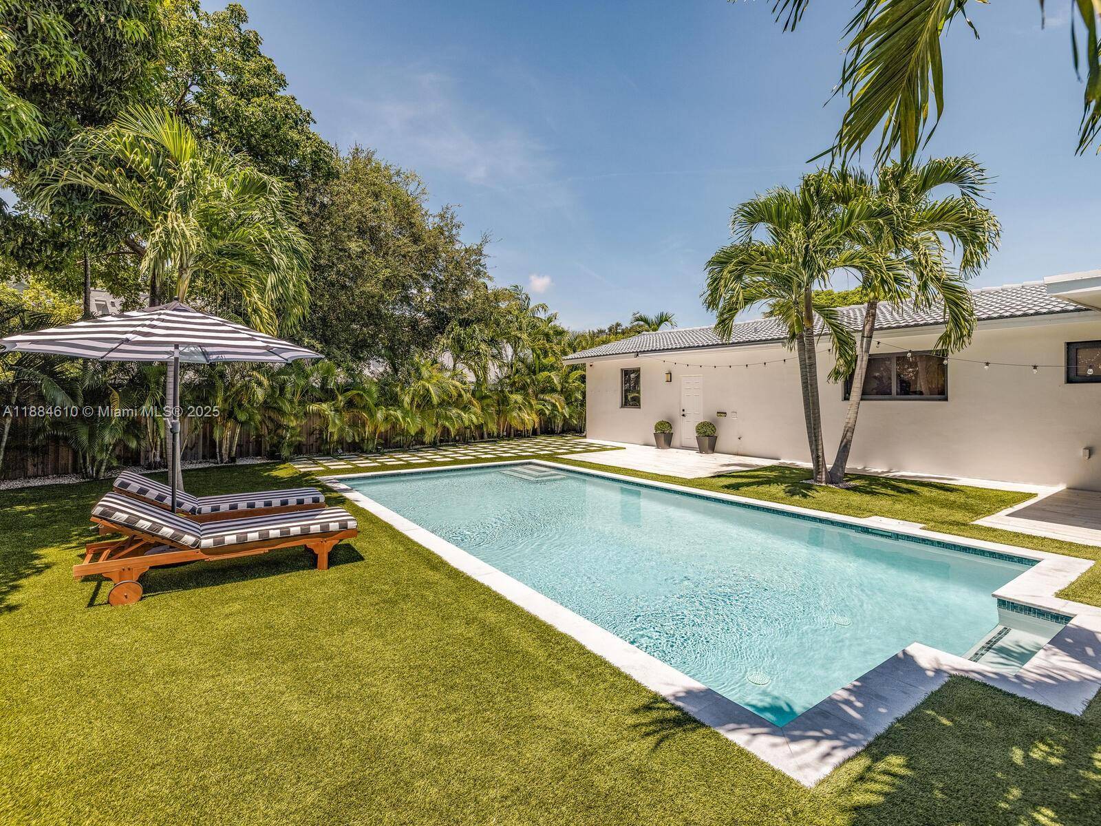 Tucked away behind a stately privacy hedge is Biscayne Park s best kept secret a just renovated midcentury pool home retreat, dripping in high end, luxe modern design.