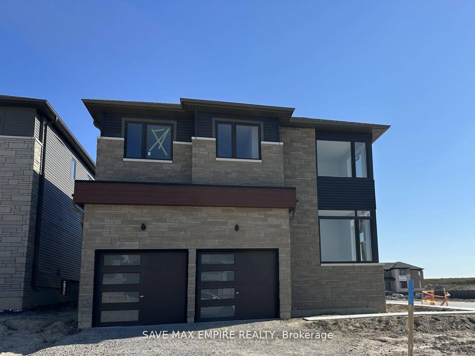 Welcome to this beautifully designed modern corner home in the sought after Rivers Edge community by Zancor.