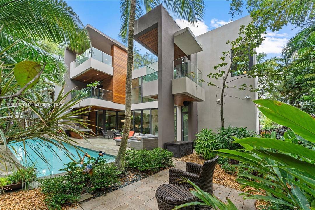 Tucked on one of North Coconut Grove s most beloved streets, this residence feels like a retreat the moment you arrive.