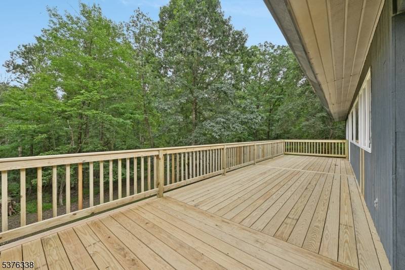 Discover your serene retreat in this custom mid century modern four bedroom, two bathroom home nestled on a private wooded lot, adjacent to a tranquil nature preserve.