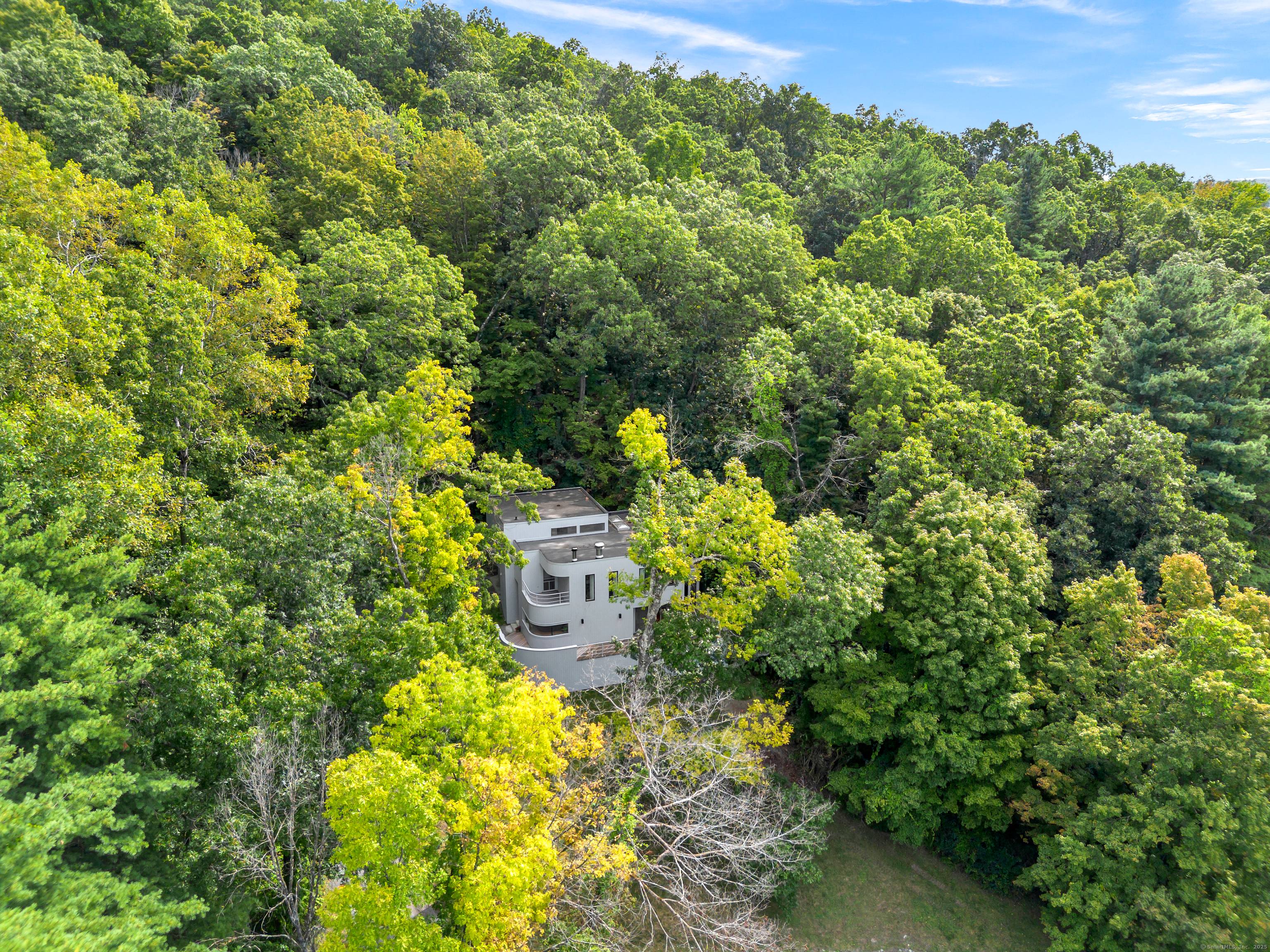 Private Hillside Contemporary with Sweeping Western Views Spectacular architect designed contemporary commanding a private hillside setting with sweeping western views over protected land.