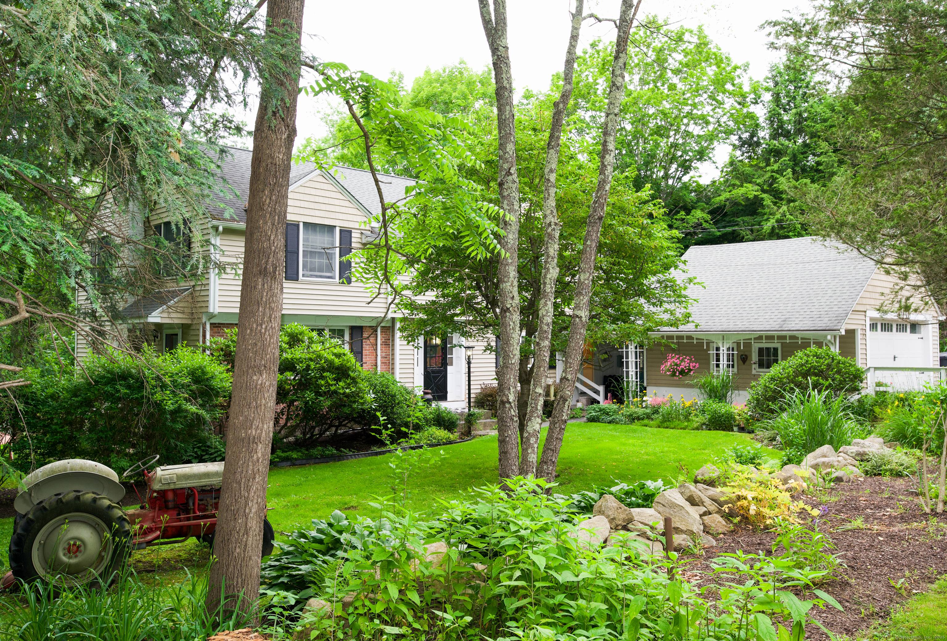 Charming Colonial boasts character and craftsmanship with wide plank pegged flooring, tray ceilings, wainscoting, and many custom built ins.