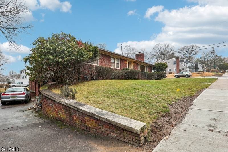 Brick Ranch on a corner lot featuring Living room with fireplace, Formal Dining room, Eat in kitchen, three Bedrooms, Enclosed porch and Full Bath.