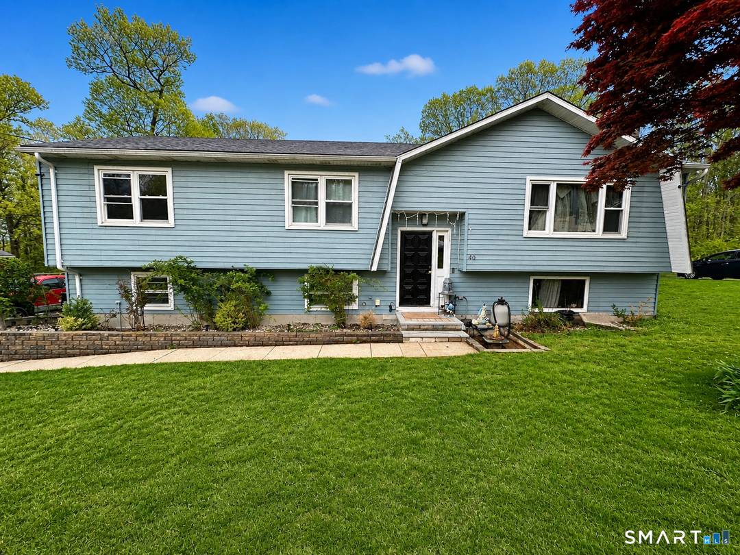 Welcome to 40 Booth Terrace, a beautifully updated Hamden home set on a spacious 0.