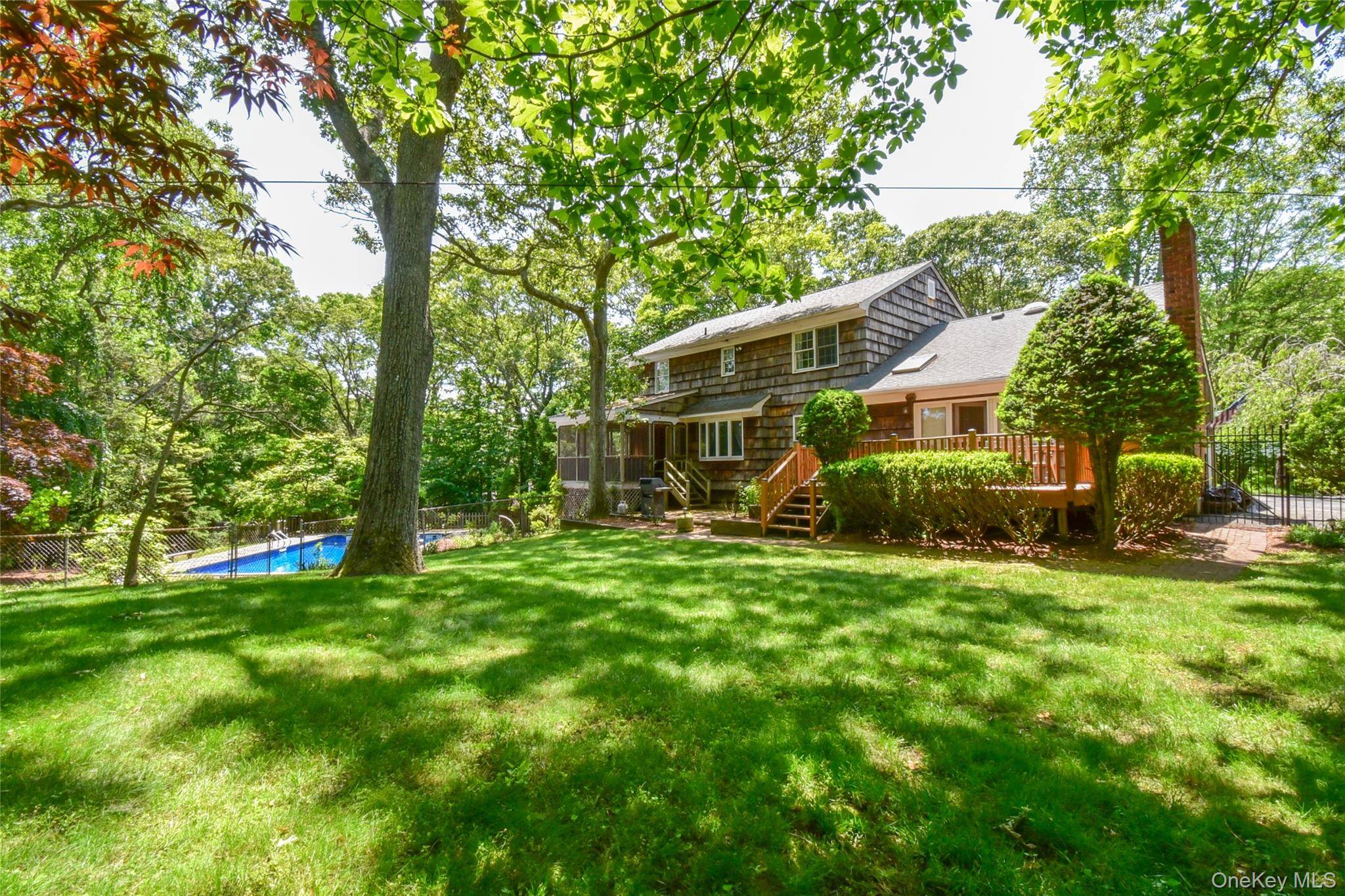 Elegant Clarendon Center Hall Colonial Nestled on a serene cul de sac in the prestigious Soundview Acres, this home offers the perfect blend of classic charm and modern comfort.