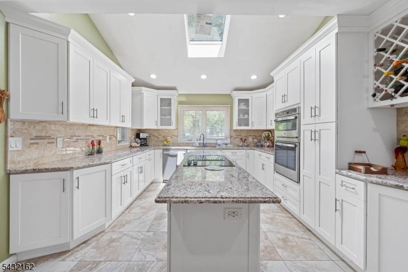 Upscale raised ranch retreat in desirable Berkeley Heights, perfect for large gatherings or entertainers.