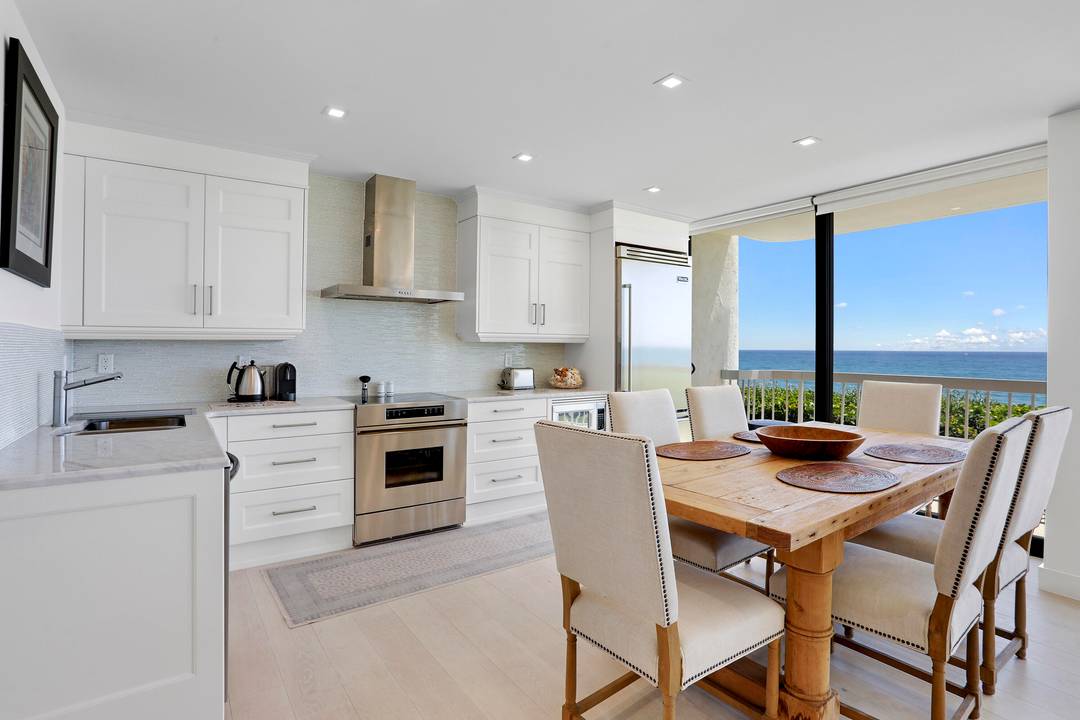 Expansive oceanfront views from this pristinely renovated three bedroom, two and a half bath second floor corner condo unit with full wrap around balcony !