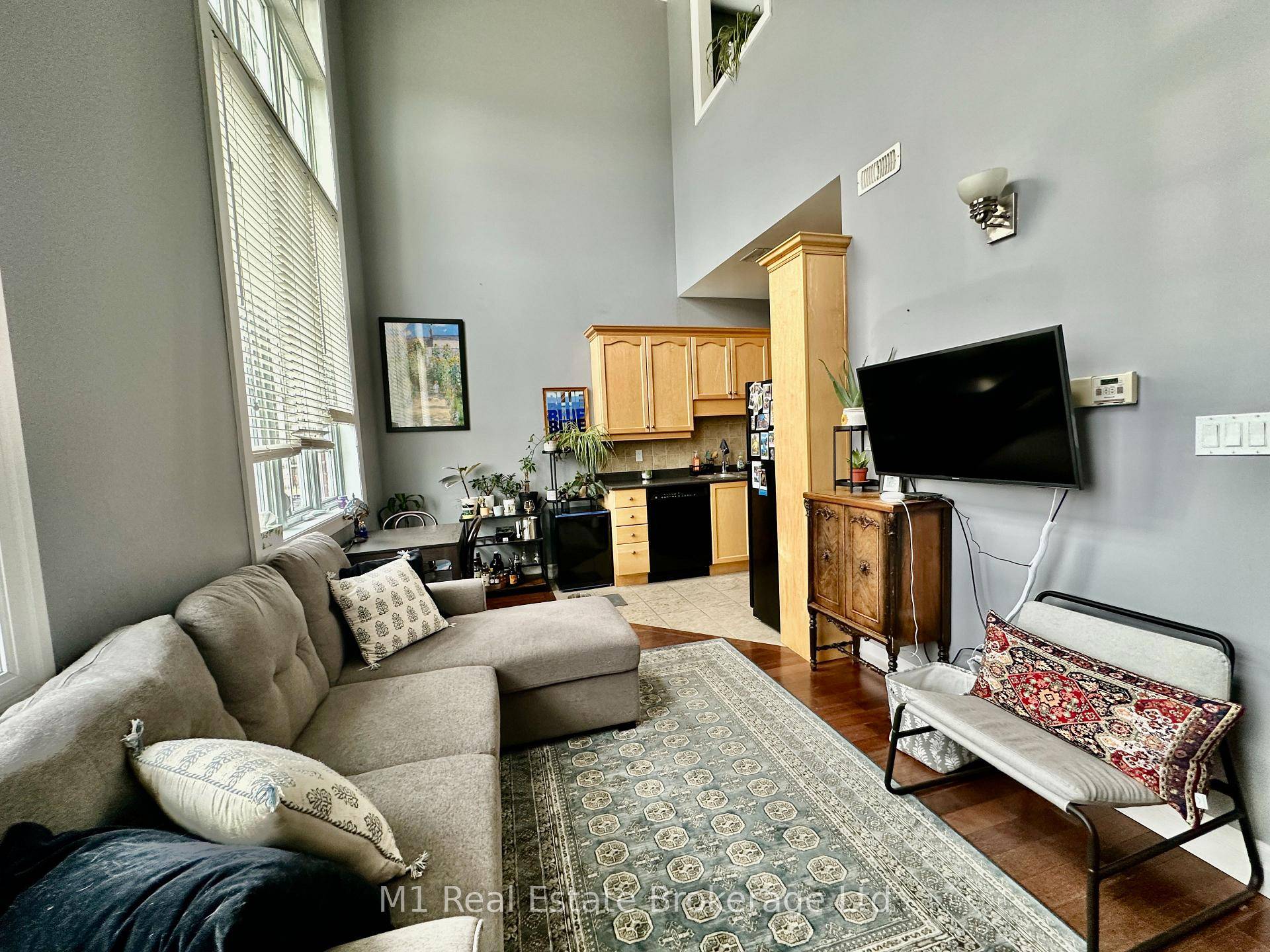 This spacious stacked townhouse features two full bedrooms, two bathrooms, high ceilings, and large windows that fill the space with natural light.