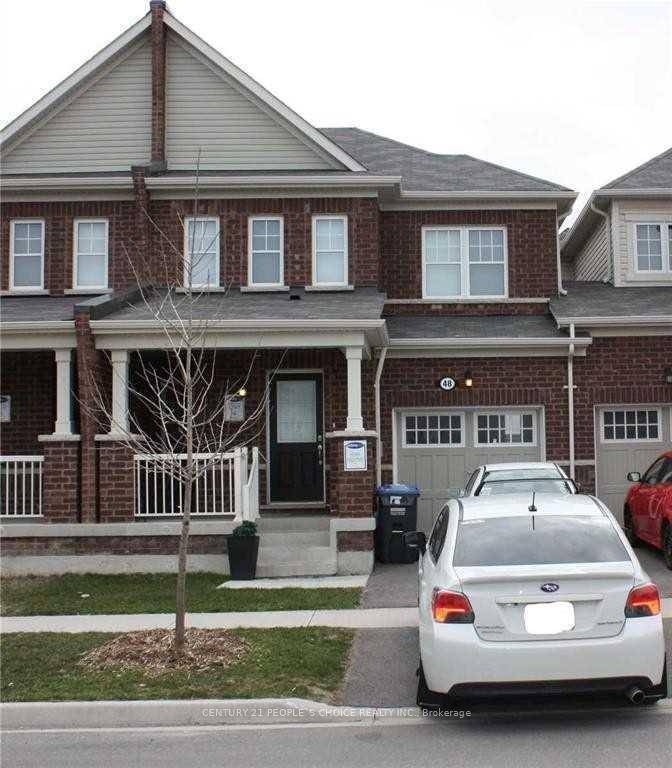 This well maintained townhouse features a spacious and functional layout, including a separate family room and living room with stylish laminate flooring.