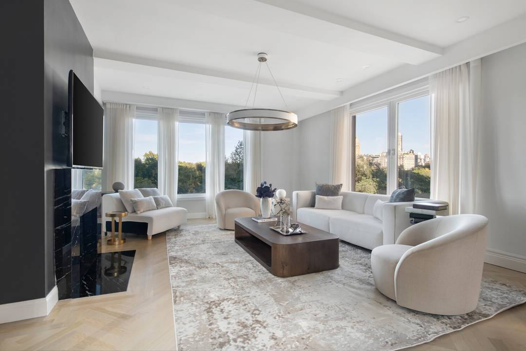 Oversized picture windows frame postcard perfect views of Central Park from every room in this elegantly renovated home.