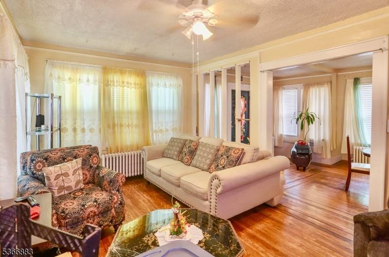 Beautiful two bedroom starter home on a fenced in lot, offering a private backyard, a wide driveway, and a detached garage.